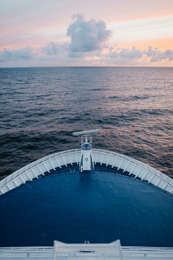 Peaceful ocean horizon captured from a cruise ship deck during tranquil sunset.